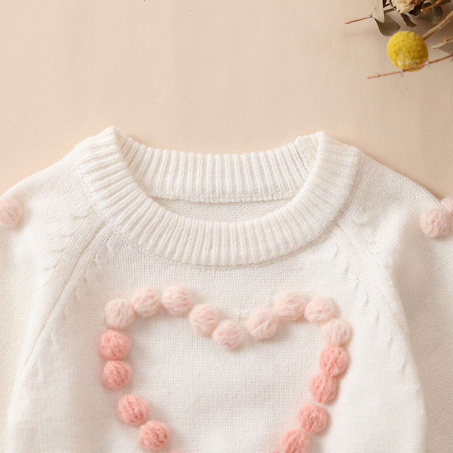 Pagliaccetto in maglia bimba con cuore in rilievo rosa