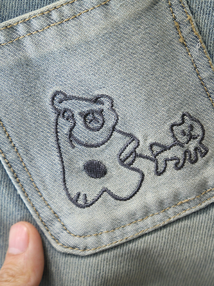 Jeans Bambino Lavaggio Chiaro con Tasche Ricamate Modello “Cute Bear”