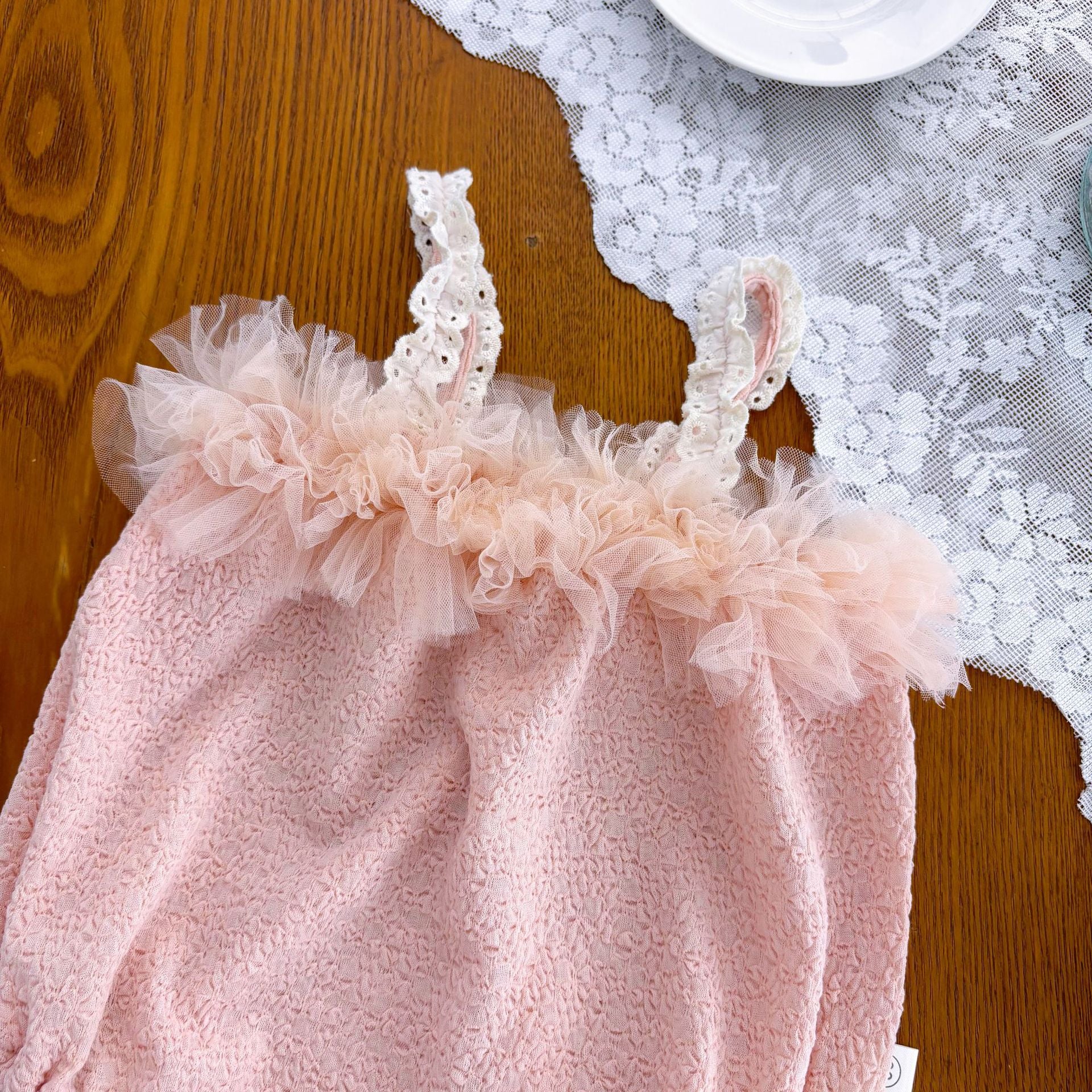 Body bimba elegante rosa cipria con volant in tulle