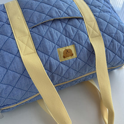 Borsa da viaggio trapuntata azzurra con manici gialli e patch orsetto
