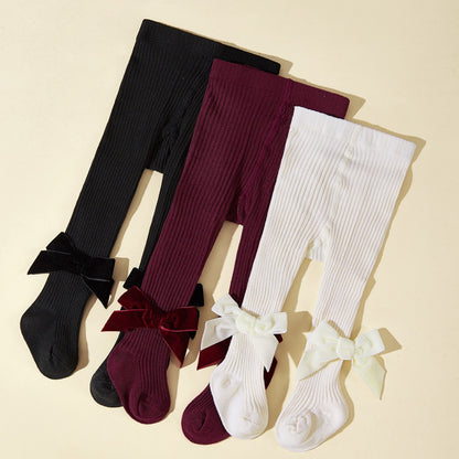 Collant bambina in maglia a costine con fiocco in velluto