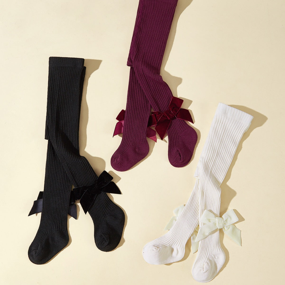 Collant bambina in maglia a costine con fiocco in velluto