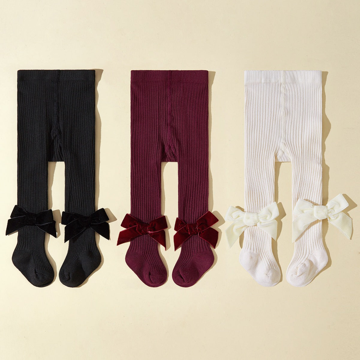 Collant bambina in maglia a costine con fiocco in velluto